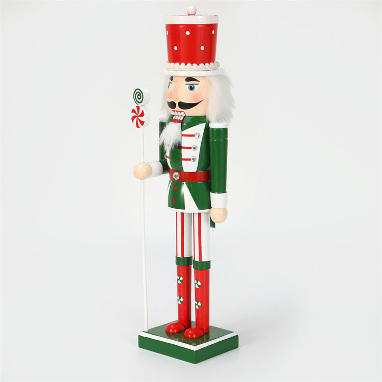 18 inch red and green christmas nutcracker soldier with lolly pop and candy cane wearing red hat and green vest and red boots-left side closeup