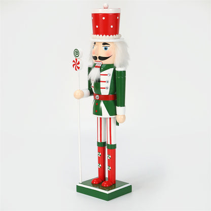 18 inch red and green christmas nutcracker soldier with lolly pop and candy cane wearing red hat and green vest and red boots-left side closeup