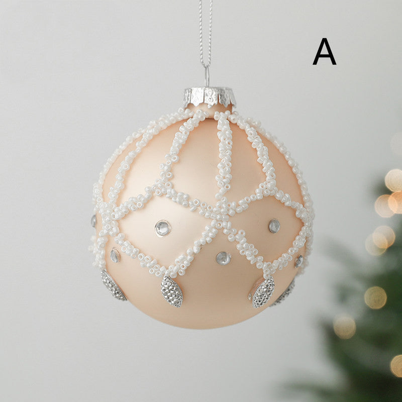 round christmas glass ornament peach colour with white decoration