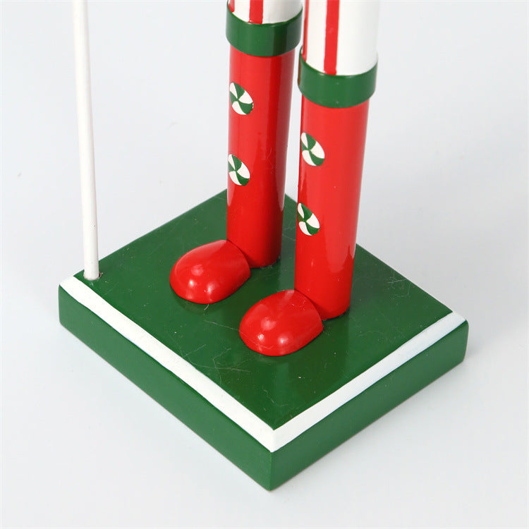 18 inch red and green christmas nutcracker soldier with lolly pop and candy cane wearing red hat and green vest and red boots-boots close up