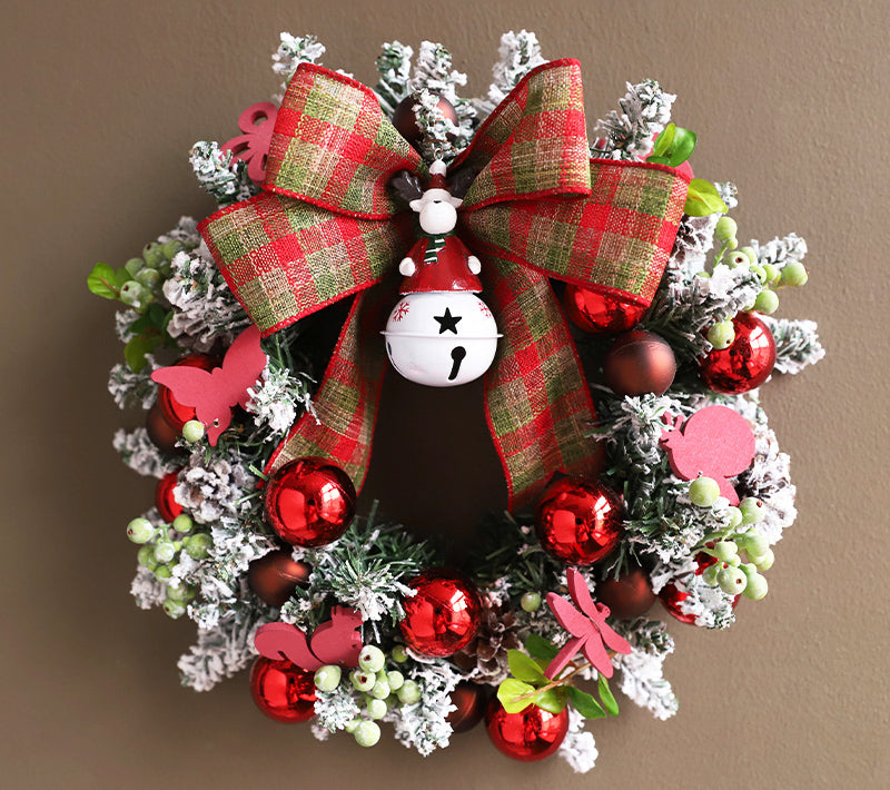 Front door Christmas wreath haven with ribbon and ornaments